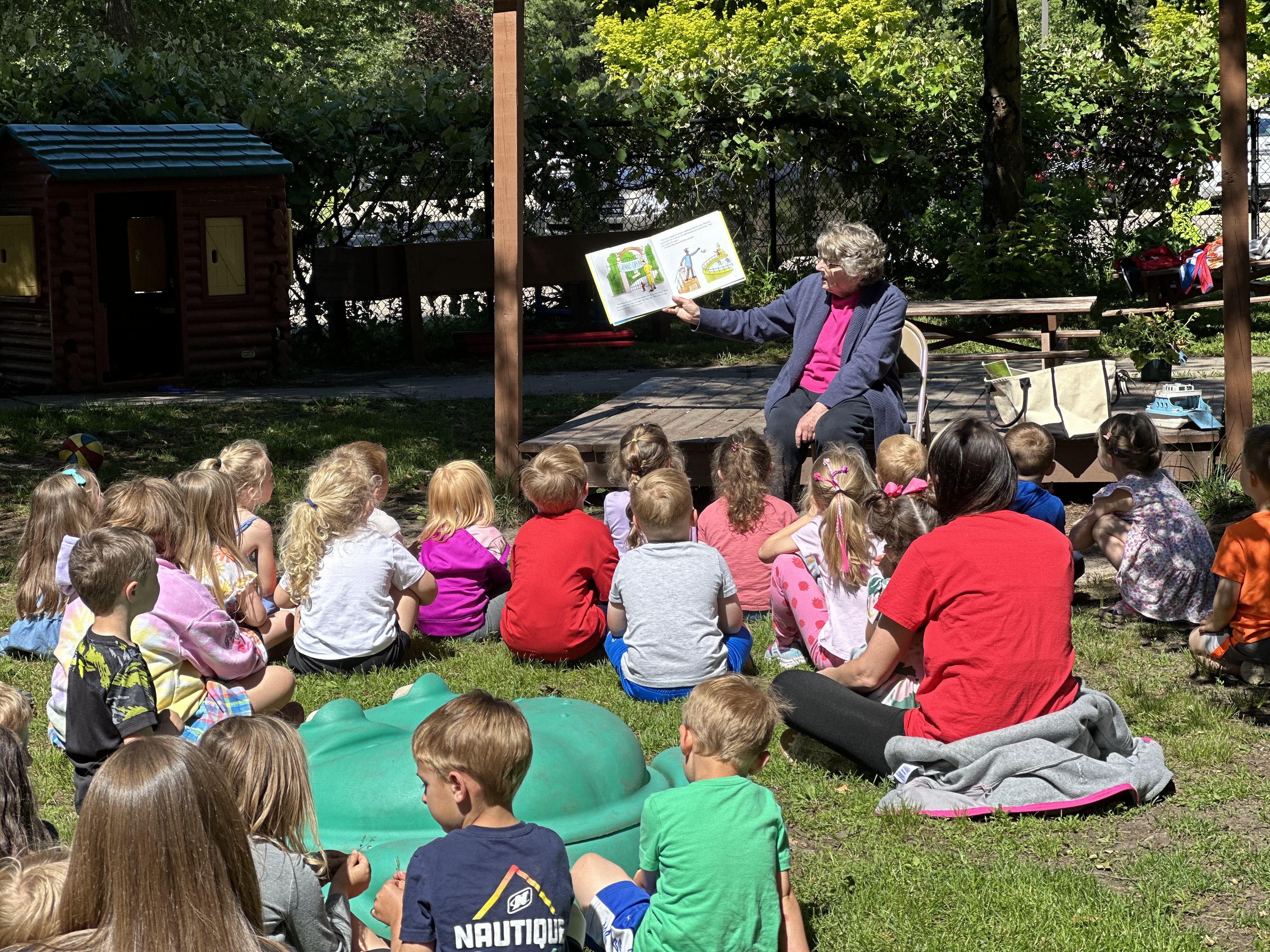 Volunteer reading to a group of children